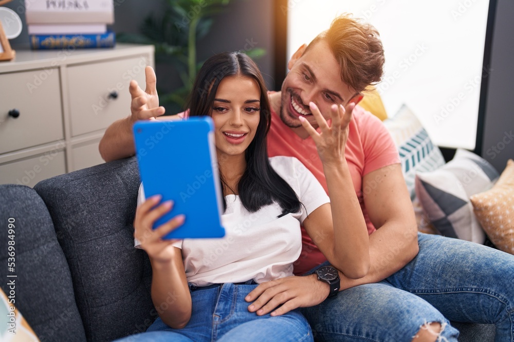 Man and woman couple using touchpad having video call at home Man and woman couple using touchpad having video call at home