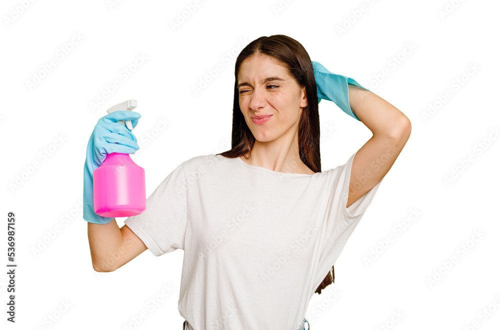 Young cleaner woman isolated touching back of head, thinking and making a choice. Young cleaner woman isolated touching back of head, thinking and making a choice.