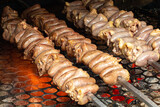 heart of roasted chicken on a spit. Barbecue being prepared on the grill grill with charcoal and hot fire.