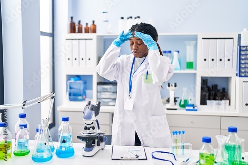 African american woman scientist holding test tube at laboratory