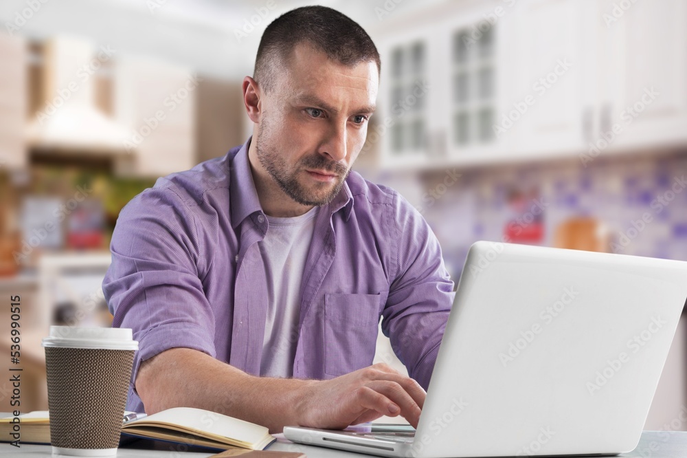 Young worker man at the table use computer