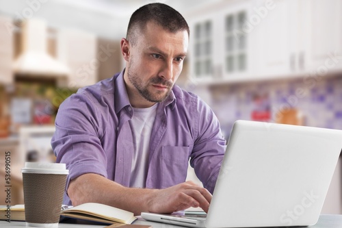 Young worker man at the table use computer
