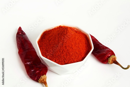 dry organic kashmiri red chili pepper whole and powder texture background selective focus,well known for dark red color food recepi in indian gujarati food isolated on white background photo