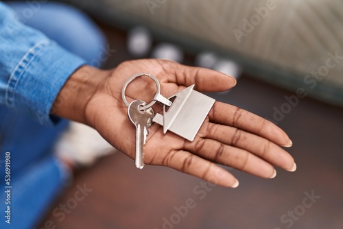 African american woman holding key at new home