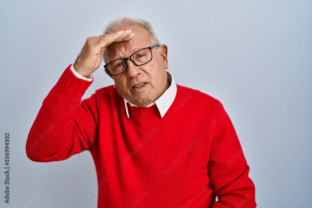 Senior man with grey hair standing over isolated background worried and stressed about a problem with hand on forehead, nervous and anxious for crisis Senior man with grey hair standing over isolated background worried and stressed about a problem with hand on forehead, nervous and anxious for crisis