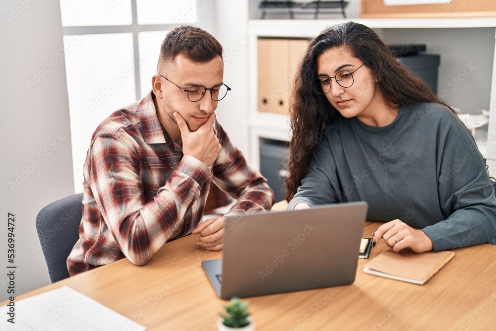 Man and woman business workers using laptop working at office Man and woman business workers using laptop working at office