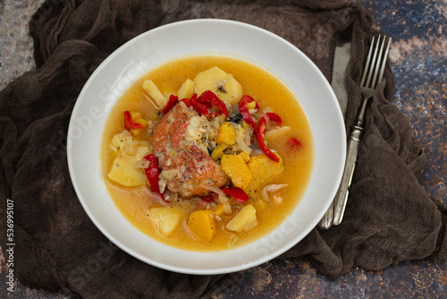 typical portuguese fish stew on white plate on ceramic