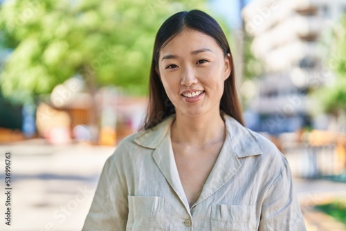 Chinese woman smiling confident standing at park