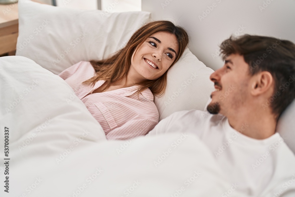 Mand and woman couple smiling confident lying on bed at bedroom Mand and woman couple smiling confident lying on bed at bedroom