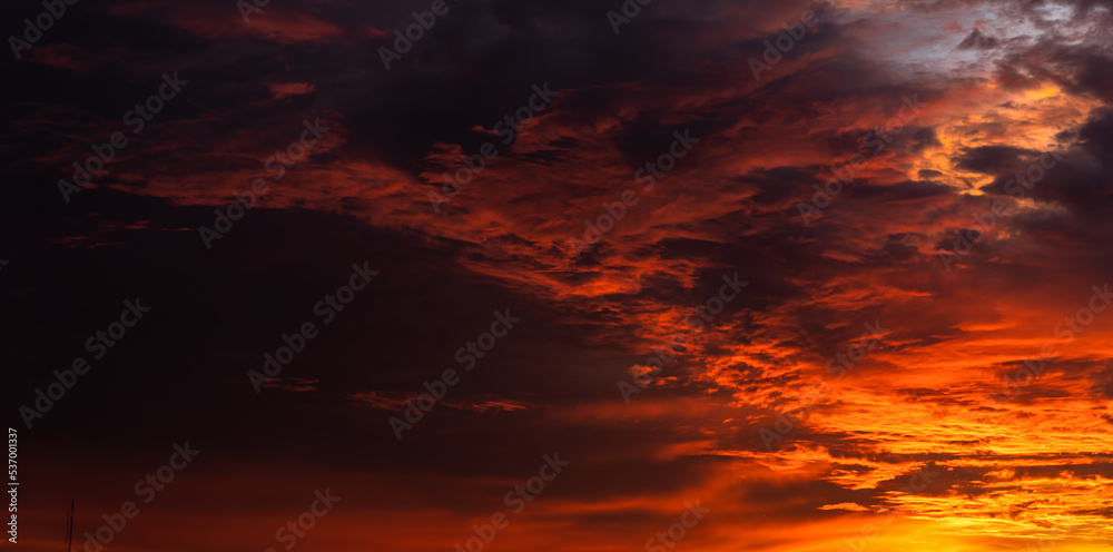 Dusk sky in the evening with colorful sunlight clouds on dark storm rain cloudy orange and red dramatic sunlight 