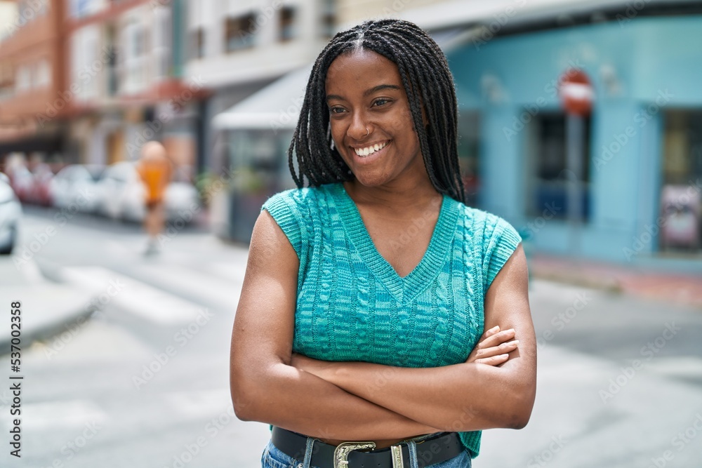 African american woman smiling confident standing with arms crossed gesture at street African american woman smiling confident standing with arms crossed gesture at street