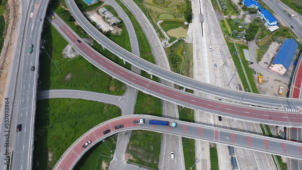 Aerial view of highway and overpass in city on a sunny day.-