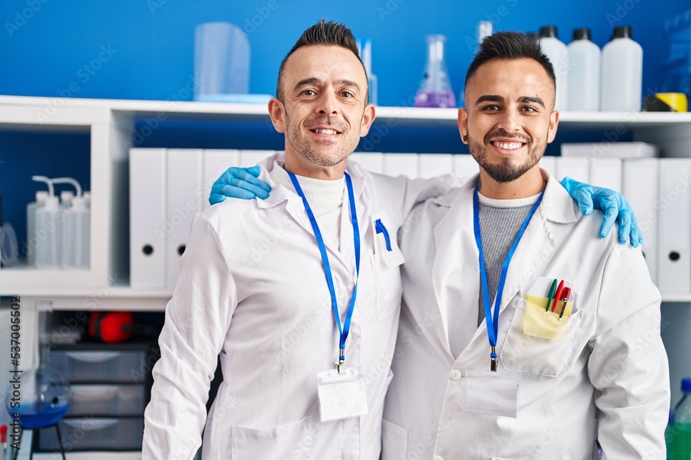 Two men scientists smiling confident hugging each other at laboratory Two men scientists smiling confident hugging each other at laboratory