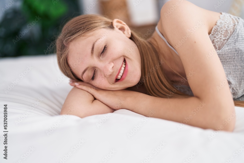 Young caucasian woman smiling confident lying on bed at bedroom Young caucasian woman smiling confident lying on bed at bedroom