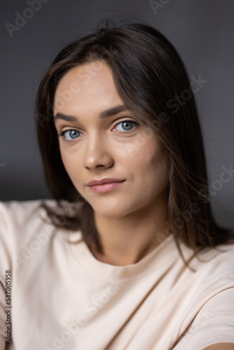 Portrait of young happy woman on grya background
