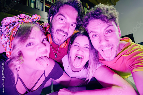 young crazy selfie at party with friends showing tongue