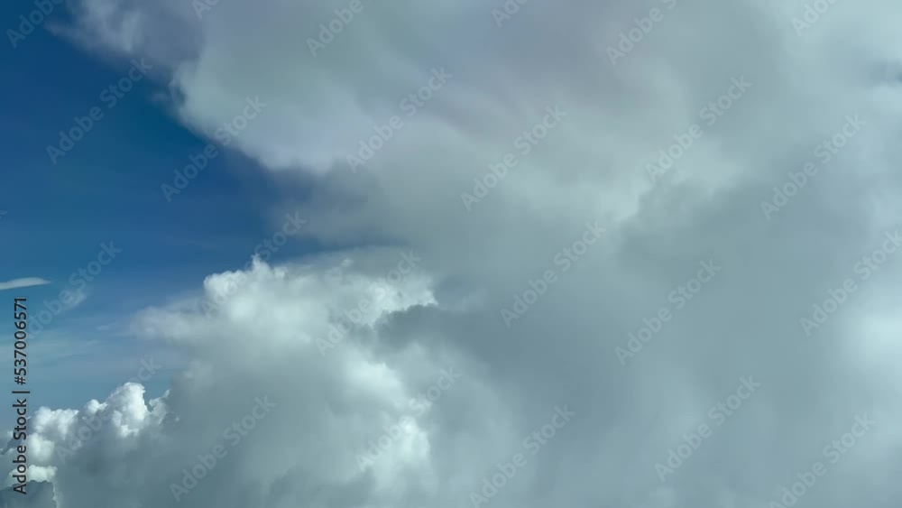 Aerial view taken from a jet cockpit flying at cruise level near a cumulus with a deep blue sky in a splendid atumn morning. Pilot point of view. Aerial view taken from a jet cockpit flying at cruise level near a cumulus with a deep blue sky in a splendid atumn morning. Pilot point of view.