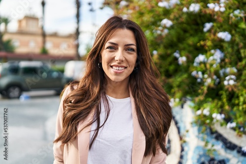 Young hispanic woman smiling confident walking at park