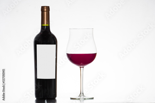 bottle of wine, with tulip glass with red wine, winery, white background