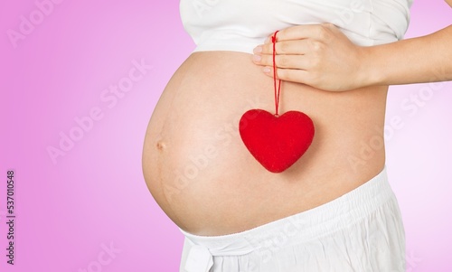 Wallpaper Mural Young woman with hands on her belly. Concept of pregnancy Torontodigital.ca