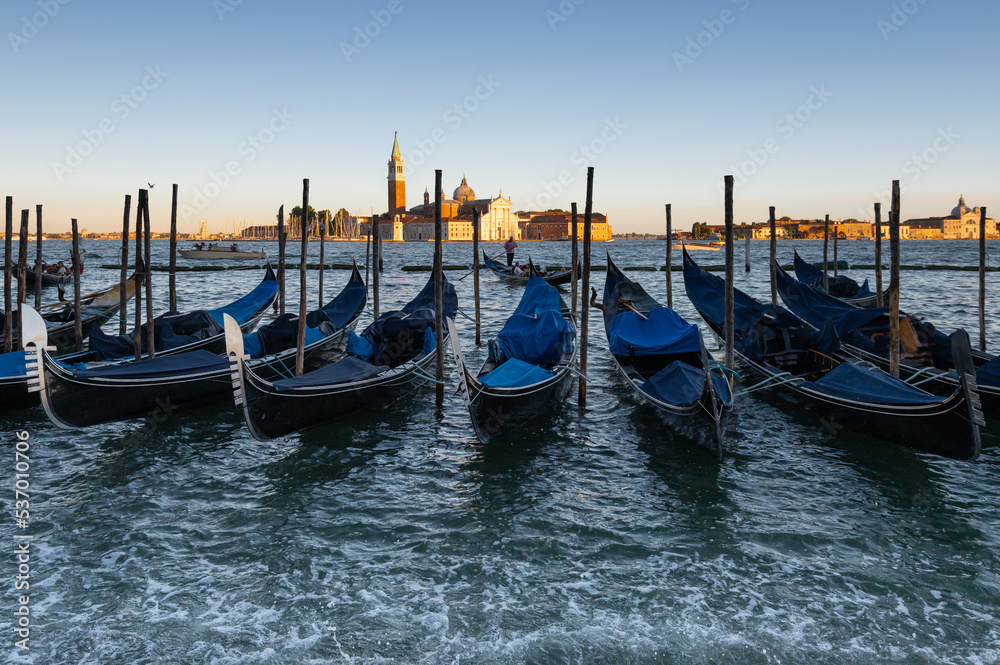 a group of gondolas on the grand canal in Venice at sunset