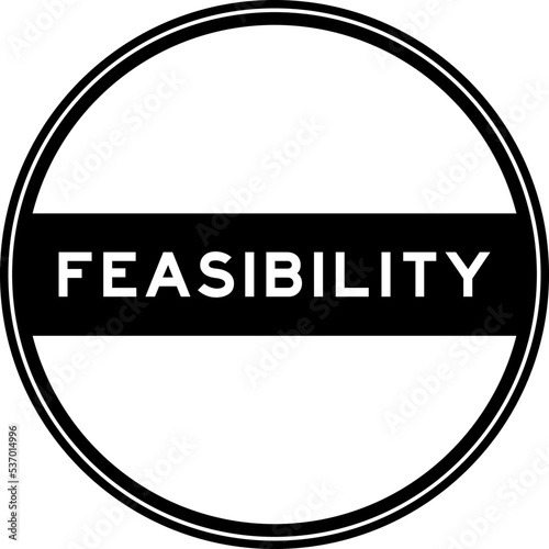 Black color round seal sticker in word feasibility on white background