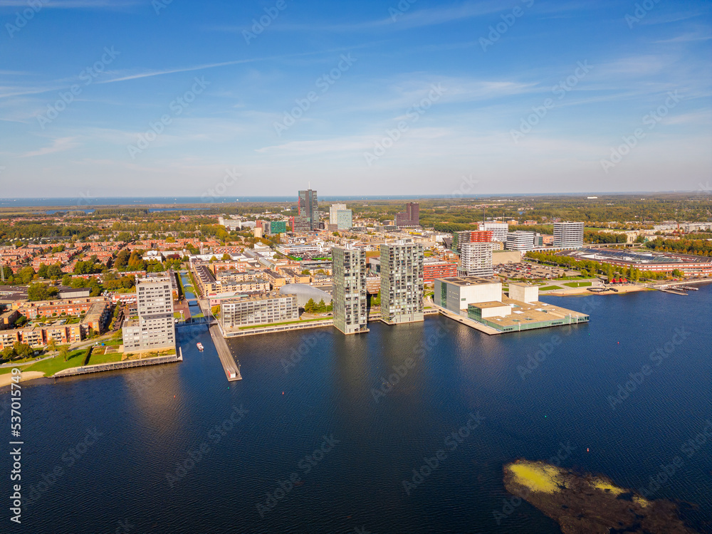 Obraz premium High angle Drone point of view on the Skyline of Almere, Flevoland, Netherlands. Almere was established in the mid-1970s and is currently the 7th largest city in The Netherlands.