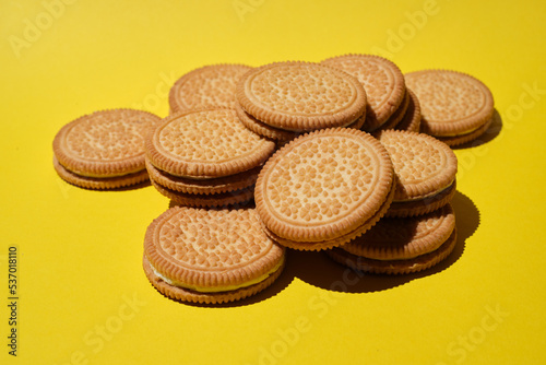 Round cookie with filling on a wooden table. Sweet cookies on bright background.