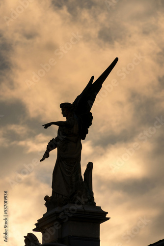 statue of an angel at sunset