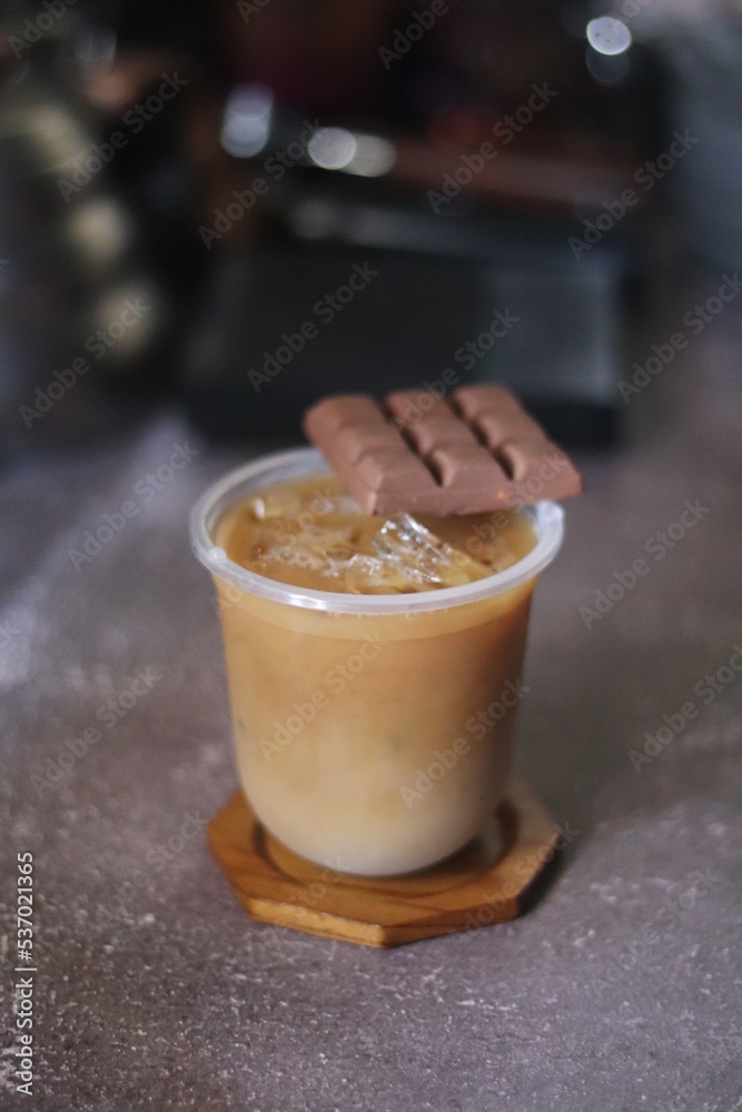 Closeup of Iced Caramel Macchiato at the coffee shop, Caramel Macchiato is a classic macchiato beverage. It consists of vanilla syrup, espresso, steamed milk, foam, and caramel drizzle Closeup of Iced Caramel Macchiato at the coffee shop, Caramel Macchiato is a classic macchiato beverage. It consists of vanilla syrup, espresso, steamed milk, foam, and caramel drizzle