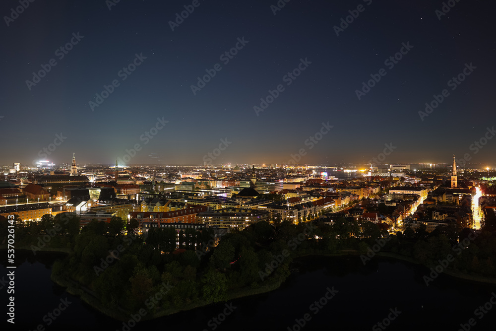 Night Copenhagen with bright streets and buildings. View from above. Panoramic view of the night city.