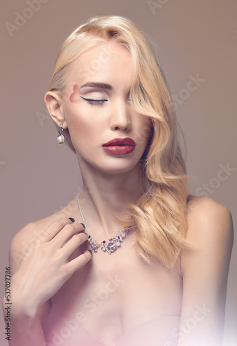 beautiful blond girl with makeup and jewelry