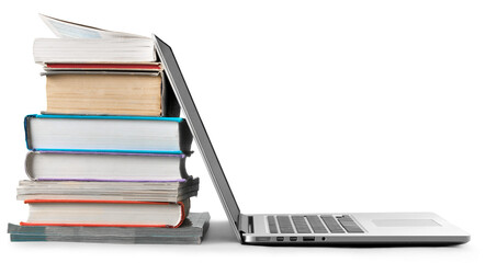 Stack of books with laptop on table