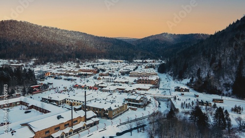 Aerial view of cityscape Bukovel surrounded by snow covered buildings and mountains photo