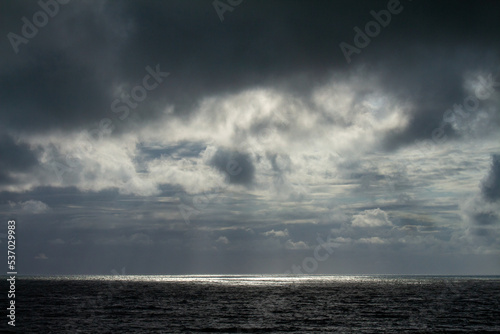 Incredible storm at sea. Sun rays breaking through the clouds.