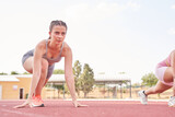 young woman training. caucasian female athlete running on an athletics track.