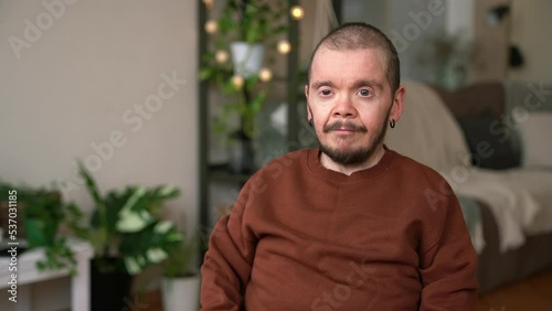 Portrait of young amn with disability sitting in wheelchair photo