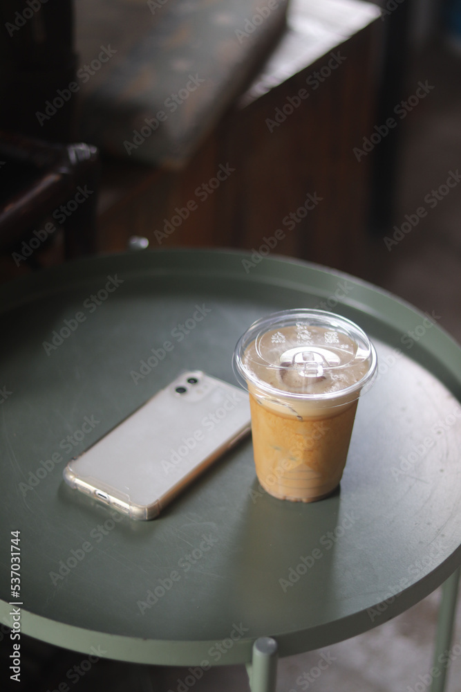 Closeup of Iced Caramel Macchiato at the coffee shop, Caramel Macchiato is a classic macchiato beverage. It consists of vanilla syrup, espresso, steamed milk, foam, and caramel drizzle Closeup of Iced Caramel Macchiato at the coffee shop, Caramel Macchiato is a classic macchiato beverage. It consists of vanilla syrup, espresso, steamed milk, foam, and caramel drizzle