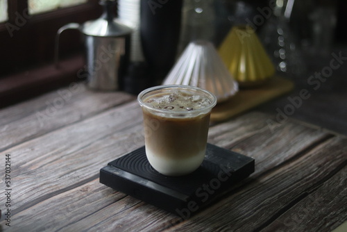 Closeup of Iced Caramel Macchiato at the coffee shop, Caramel Macchiato is a classic macchiato beverage. It consists of vanilla syrup, espresso, steamed milk, foam, and caramel drizzle