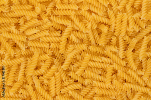 Spiral pasta background texture closeup