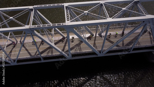 Aerial view of cyclist riding on the bridge during early morning hours.
