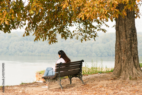 Girl enjoying tranquil Belgrade panorama and Sava river view on bench in the park Kalemegdan in Belgrade Serbia