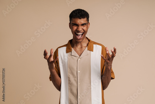 Obraz na plátně Young handsome insidious african man with piercing with raised hands