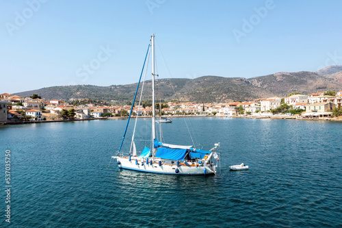 Galaxidi Greece. Sailboat anchored, traditional waterfront houses background.