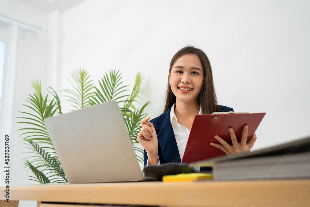 Happy young Asian women startup entrepreneur happy and excited smiling after getting email for success sign business contact, happy girl on the workplace. Distance learning online education and work. Happy young Asian women startup entrepreneur happy and excited smiling after getting email for success sign business contact, happy girl on the workplace. Distance learning online education and work.