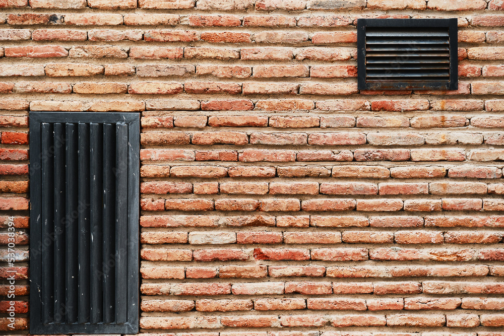 Brick dam wall with ventilation grilles, advertising background or