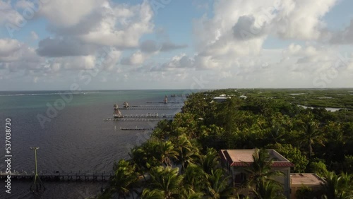 Aerial drone view of boat docks and blue sea on the tropical Caribbean Island of Ambergris Caye, San Pedro in Belize. 