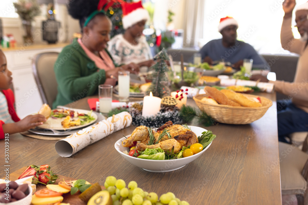 African american family spending time together at the table having a christmas meal