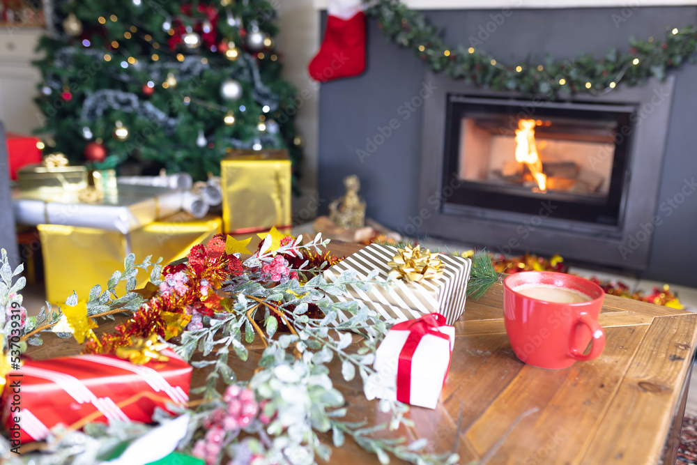 A modern living room decorated with christmas decorations, a christmas tree and gifts