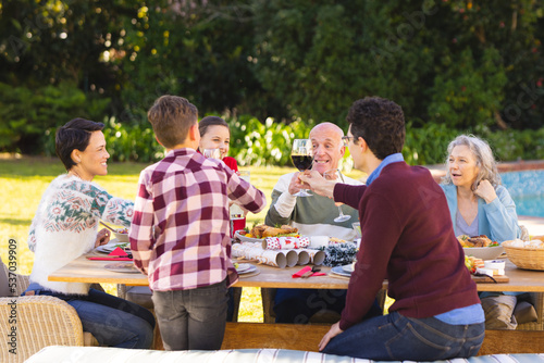 Caucasian family spending time together outside and having meal